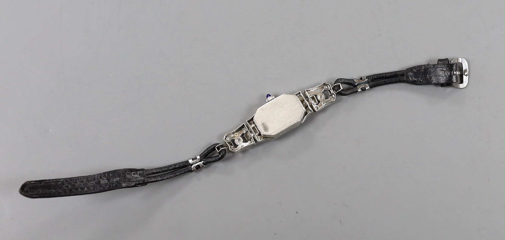A lady's 1940's white metal (stamped plat) and diamond set manual wind cocktail watch, with Arabic dial, on fabric strap, gross weight 15.7 grams.